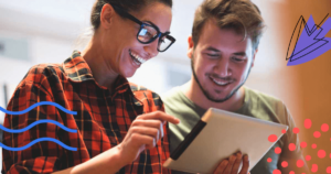 Two people smiling looking at a tablet